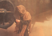 Luke pulls on his black glove, covering his mechanical hand.  From the Star Wars Insider #35.