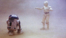 Threepio and Artoo surrounded by blowing sand.  From the Star Wars Insider #35.